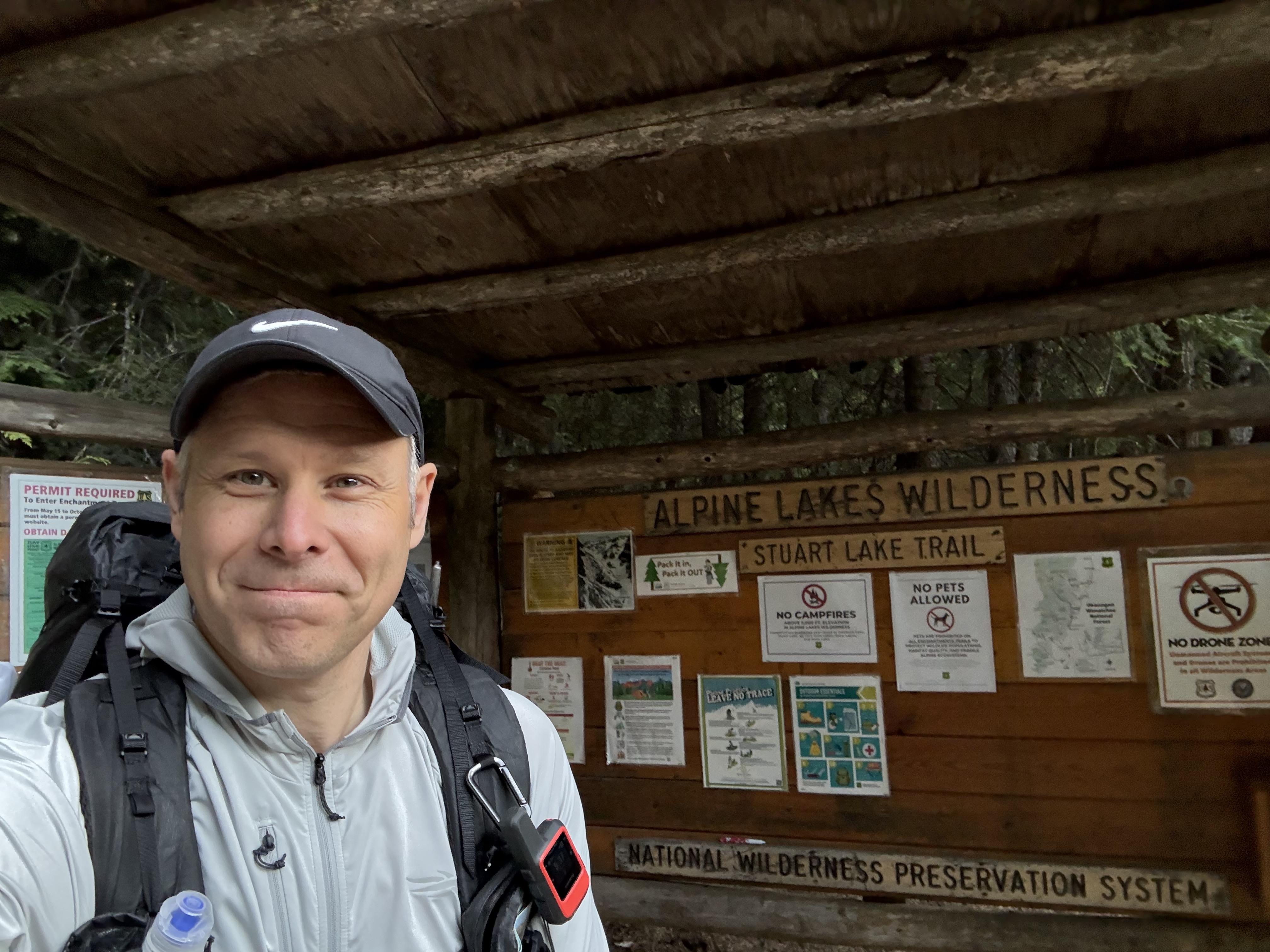 Shane at the Alpine Lakes Wilderness trailhead sign with full pack