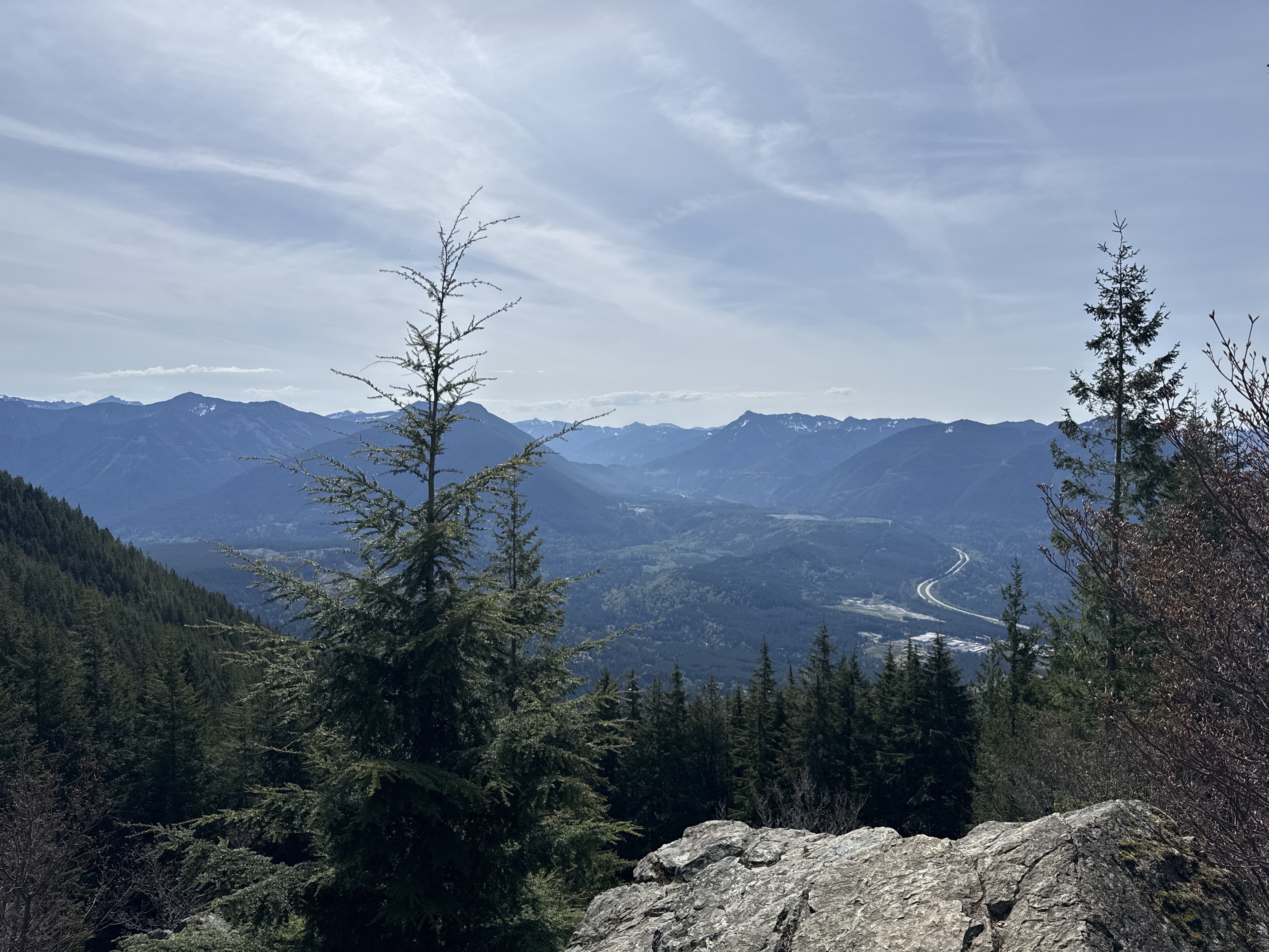 Snoqualmie Valley and I-90 visible through trees from the Mount Si talus slope